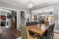 a dining room with a wooden table and chairs