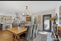 a kitchen with a dining table and chairs