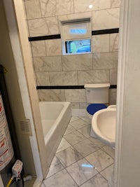 a bathroom with a sink, toilet and tub