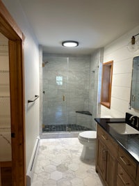 a bathroom with a sink, toilet and shower