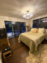 a bedroom with sliding glass doors and a bed