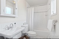 a white bathroom with a toilet and sink
