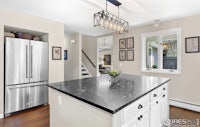 a kitchen with marble counter tops and stainless steel appliances