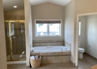 a bathroom with a tub, sink and toilet