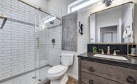 a bathroom with a shower stall and a sink