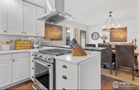 a kitchen with white cabinets and a stove