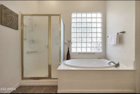 a bathroom with a tub and shower in it